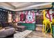 Sophisticated media room featuring a sectional sofa, eclectic artwork, and a yellow giraffe sculpture at 6240 N 59Th Pl, Paradise Valley, AZ 85253