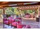Covered patio with seating area, built-in BBQ, and pergola at 6240 N 59Th Pl, Paradise Valley, AZ 85253