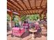 Relaxing patio with pergola, string lights, and pink seating at 6240 N 59Th Pl, Paradise Valley, AZ 85253