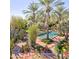 Inviting pool area surrounded by lush landscaping and desert plants at 6240 N 59Th Pl, Paradise Valley, AZ 85253