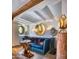 Small sitting area features a teal velvet sofa and eclectic decor at 6240 N 59Th Pl, Paradise Valley, AZ 85253
