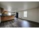 Open-concept living area adjacent to the kitchen, featuring dark wood-look flooring at 625 W Mckellips Rd # 161, Mesa, AZ 85201