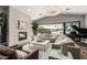 Elegant living room with a fireplace, piano, and large windows at 6705 E Lafayette Blvd, Scottsdale, AZ 85251