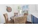 Charming breakfast nook with a round wooden table and four wicker chairs at 7332 E Montebello Ave, Scottsdale, AZ 85250