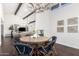 Bright dining area with a rustic wooden table and blue chairs, and view of living room at 7332 E Montebello Ave, Scottsdale, AZ 85250