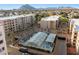 Aerial view of community pool, hot tub, and building at 7860 E Camelback Rd # 209, Scottsdale, AZ 85251