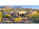 Aerial view of a stunning home with mountain backdrop and a private pool at 8300 E Dixileta Dr # 279, Scottsdale, AZ 85266