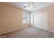 Bright bedroom with ceiling fan and sliding door at 10419 E Kiva Ave, Mesa, AZ 85209