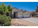 Two-story house with three car garage and desert landscaping at 10419 E Kiva Ave, Mesa, AZ 85209