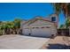 Two-story house with three car garage and desert landscaping at 10419 E Kiva Ave, Mesa, AZ 85209