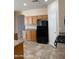 Kitchen features wood cabinets and black appliances at 10419 E Kiva Ave, Mesa, AZ 85209