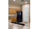 View of kitchen with black appliances and pantry at 10419 E Kiva Ave, Mesa, AZ 85209