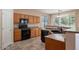Kitchen with wood cabinets, black appliances, and a breakfast bar at 10419 E Kiva Ave, Mesa, AZ 85209