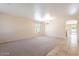 Spacious living room with carpet and tile flooring, neutral wall colors at 10419 E Kiva Ave, Mesa, AZ 85209