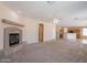 Large living room with fireplace and access to kitchen at 10419 E Kiva Ave, Mesa, AZ 85209