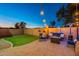 Landscaped backyard with a grassy area and patio at 11828 W Donald Dr, Sun City, AZ 85373