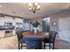 Charming dining area with a round wooden table and gray chairs at 11828 W Donald Dr, Sun City, AZ 85373