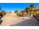 Large backyard with gravel, grass, and palm trees at 123 S Cobblestone Dr, Gilbert, AZ 85296