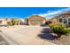 Tan house with tile roof, two-car garage, and desert landscaping at 123 S Cobblestone Dr, Gilbert, AZ 85296