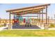 Covered playground with play structures, picnic tables, and grassy area at 12544 W Parkway Ln, Avondale, AZ 85323