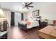 Spacious bedroom with dark wood furniture and ceiling fan at 15519 E Chicory Dr, Fountain Hills, AZ 85268