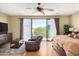 Main bedroom with hardwood floors, sliding doors to a private balcony, and relaxing seating area at 15519 E Chicory Dr, Fountain Hills, AZ 85268