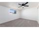 Bright bedroom with ceiling fan and neutral carpeting at 174 W 15Th Ave, Apache Junction, AZ 85120