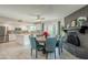 Dining area with round table, brick fireplace, and view of the kitchen at 17403 N 36Th St, Phoenix, AZ 85032