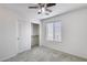 Bright bedroom with ceiling fan, large closet, and window coverings at 17409 W Holland Ln, Surprise, AZ 85388