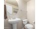 Clean bathroom with pedestal sink and toilet at 18250 N Cave Creek Rd # 163, Phoenix, AZ 85032