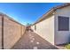 Side yard pathway leads to a covered patio area at 18485 N Miller Way, Maricopa, AZ 85139