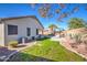 Landscaped backyard with grassy area and desert plants at 18485 N Miller Way, Maricopa, AZ 85139