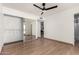 Bedroom with mirrored closet doors and wood-look flooring at 2154 W Edgewood Ave, Mesa, AZ 85202