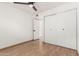 Simple bedroom with double door closet and wood-look flooring at 2154 W Edgewood Ave, Mesa, AZ 85202