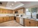 Modern kitchen with stainless steel appliances and light wood cabinets at 26617 S Sedona Dr, Sun Lakes, AZ 85248