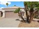 Front exterior of a home with palm trees and desert landscaping at 4714 E Charleston Ave, Phoenix, AZ 85032