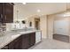 Kitchen with granite countertops, dark cabinets, and view to living room at 5350 E Deer Valley Dr # 3418, Phoenix, AZ 85054