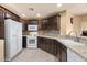 Kitchen with granite countertops and dark wood cabinets at 5350 E Deer Valley Dr # 3418, Phoenix, AZ 85054