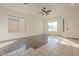 Bright living room with wood-look floors and ceiling fan at 6030 W Kimberly Way, Glendale, AZ 85308