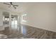 Sunlit living room featuring wood-look floors and a ceiling fan at 6030 W Kimberly Way, Glendale, AZ 85308