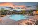 Community pool at sunset with lounge chairs and mountain backdrop at 6814 E San Cristobal Way, Gold Canyon, AZ 85118