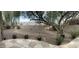 Landscaped backyard with gravel, mature trees, and a patio area at 8846 E Copper Dr, Sun Lakes, AZ 85248