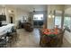Open dining area with glass table and chairs, adjacent to kitchen and living room at 8846 E Copper Dr, Sun Lakes, AZ 85248
