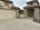 Home's exterior with two-car garage and arched entryway at 8846 E Copper Dr, Sun Lakes, AZ 85248