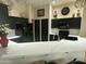 Modern kitchen with dark cabinetry, quartz countertops, and stainless steel appliances at 8846 E Copper Dr, Sun Lakes, AZ 85248