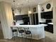 Modern kitchen with dark cabinetry, breakfast bar, and stainless steel appliances at 8846 E Copper Dr, Sun Lakes, AZ 85248