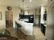 Modern kitchen with dark cabinetry, quartz countertops, and an island with seating at 8846 E Copper Dr, Sun Lakes, AZ 85248