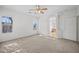 Carpeted bedroom with ensuite bathroom access and ceiling fan at 885 W Tremaine Ave, Gilbert, AZ 85233