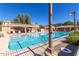 Community pool with a spa, lounge chairs, and covered seating at 10268 W Sands Dr # 490, Peoria, AZ 85383