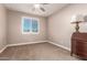 Simple carpeted bedroom with antique wooden desk at 13524 W Sierra Vista Dr, Glendale, AZ 85307